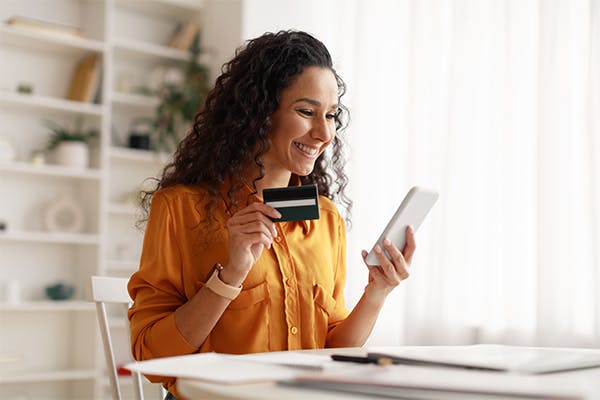 https://tower.top10posproviders.com/wp-content/uploads/2023/08/Cheerful-Arabic-Woman-Using-Smartphone-Shopping-Online-Holding-Credit-Card-Making-Payment-Sitting-At-Desk-At-Home.jpg